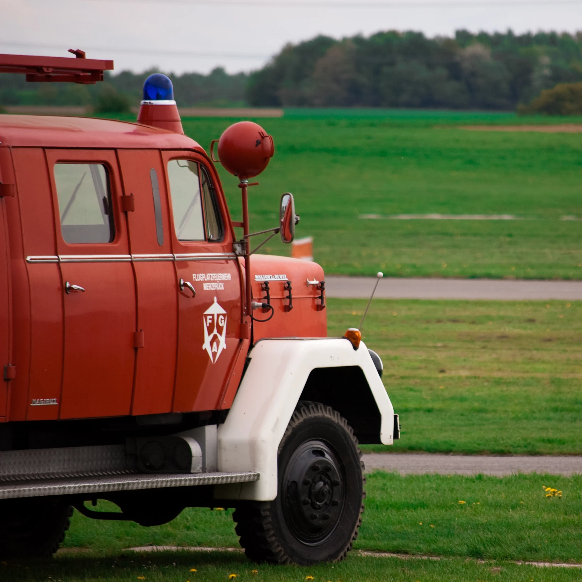 the back end of a truck parked in the grass