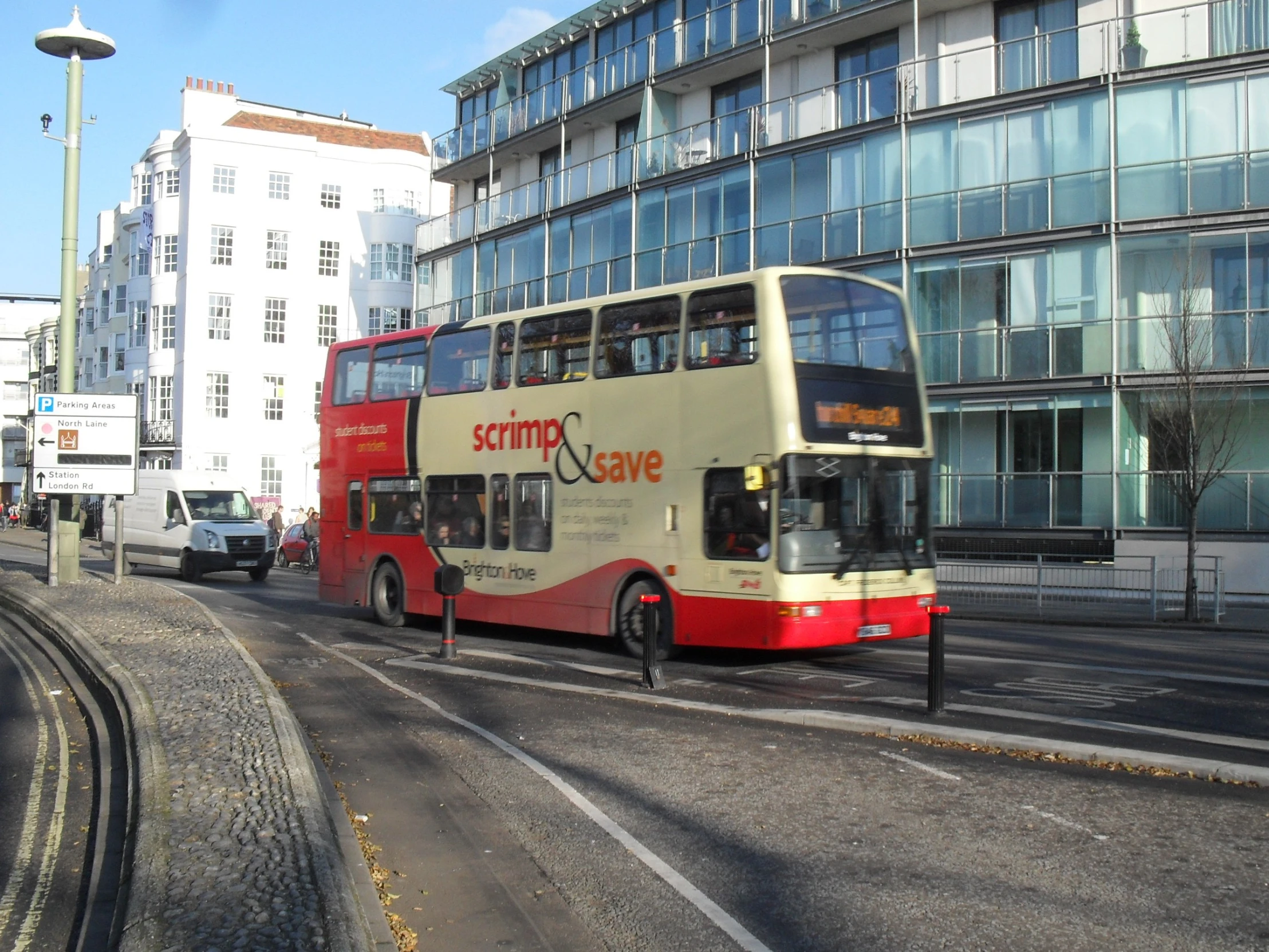 the bus is driving down the street in front of tall buildings