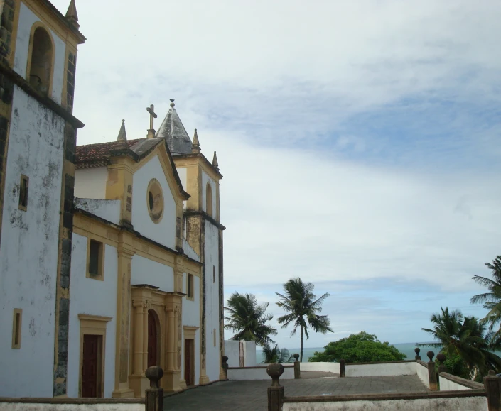 an old, white building with gold trim