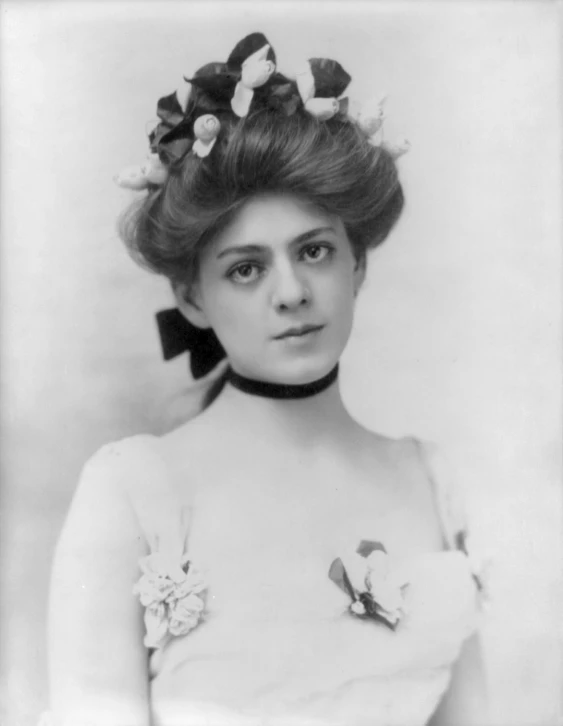 a woman with long hair wearing flowers in her hair