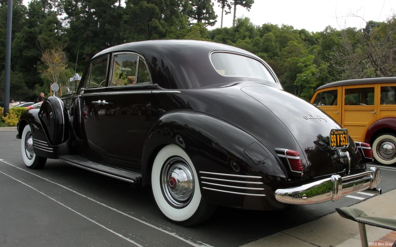 an old model, nice looking car parked at a parking lot