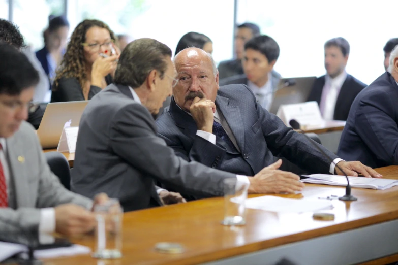 several business men sitting around a conference table