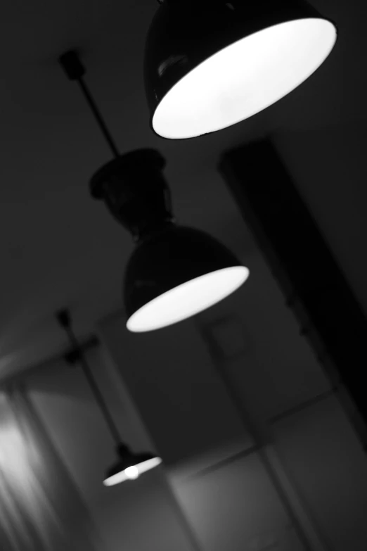 three lights are hanging in the dark above a doorway