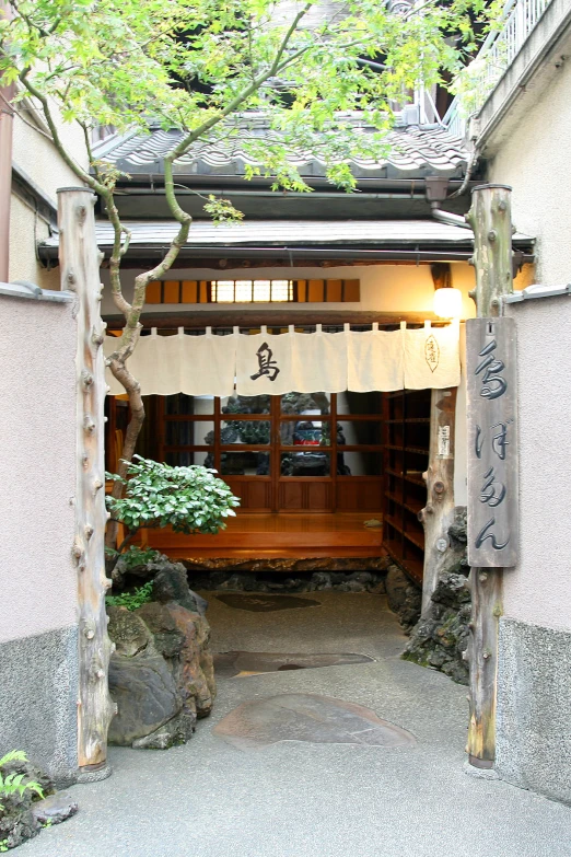 a small shrine is decorated with trees and lanterns