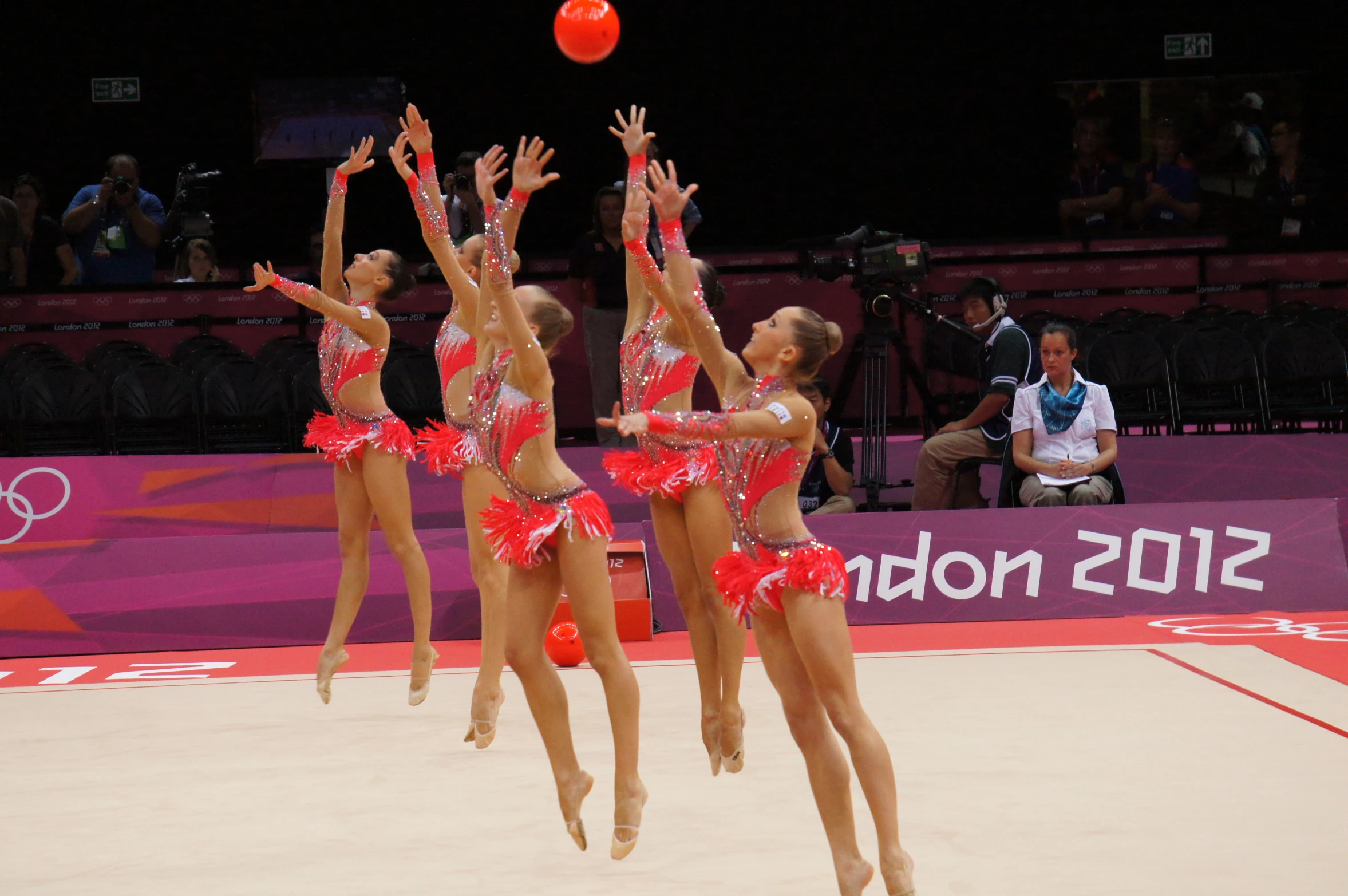 a group of young women standing on top of a basketball court