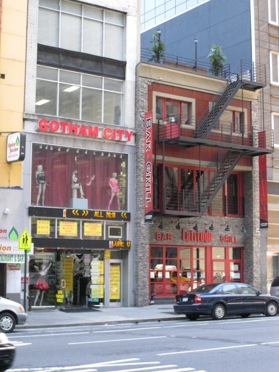 the red and grey building is behind a fire escape