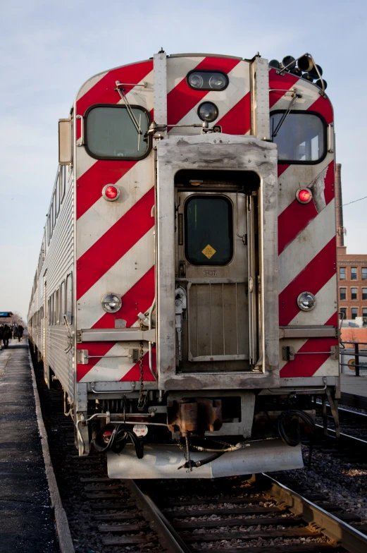 an open door train car parked on the tracks