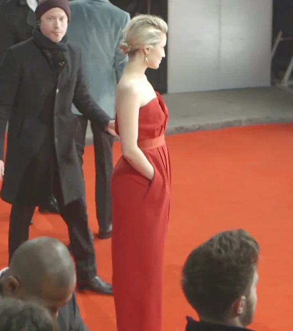 a man and a woman are standing together on a red carpet