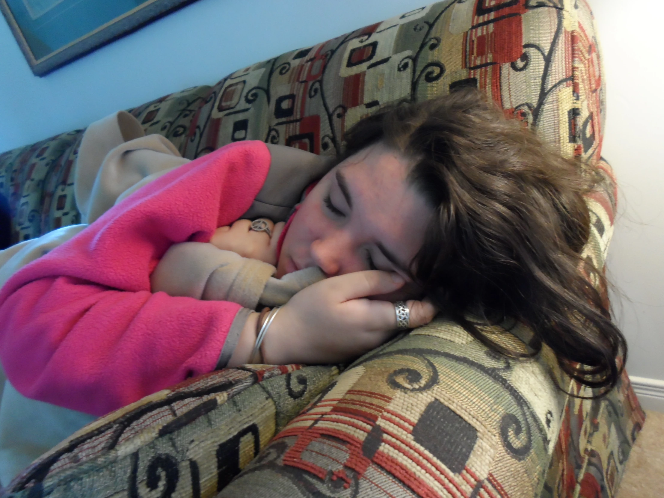 a woman is laying on a couch with her head in her hand