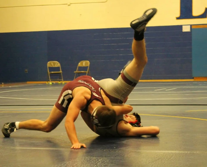 wrestling wrestler being pinned in the middle by opponent