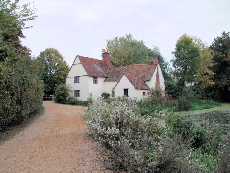 an old country house sits near a wooded area