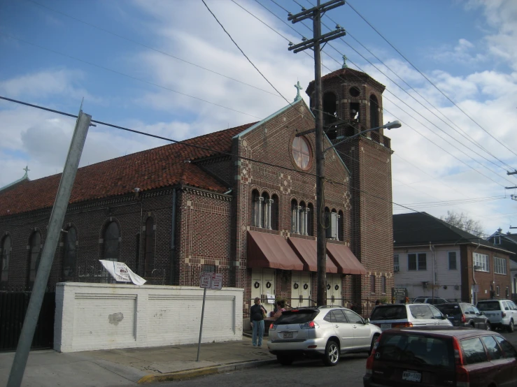 the view of a brick building near the street and cars