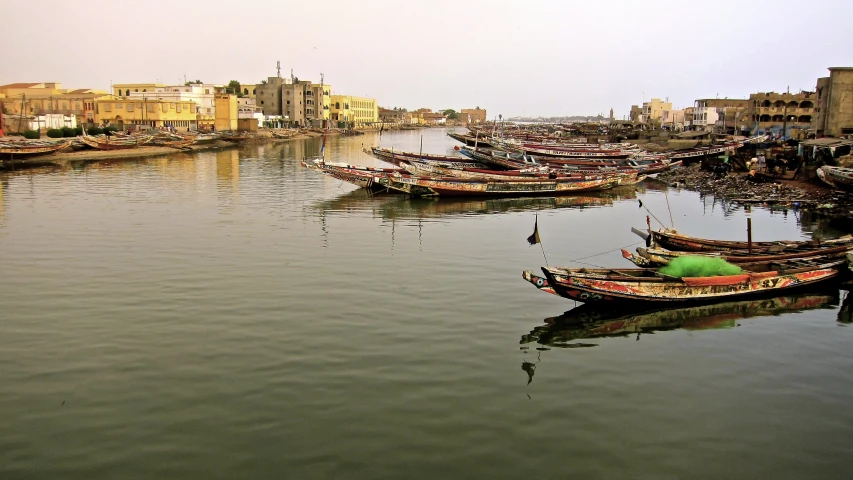 boats are floating in the calm waters in a marina