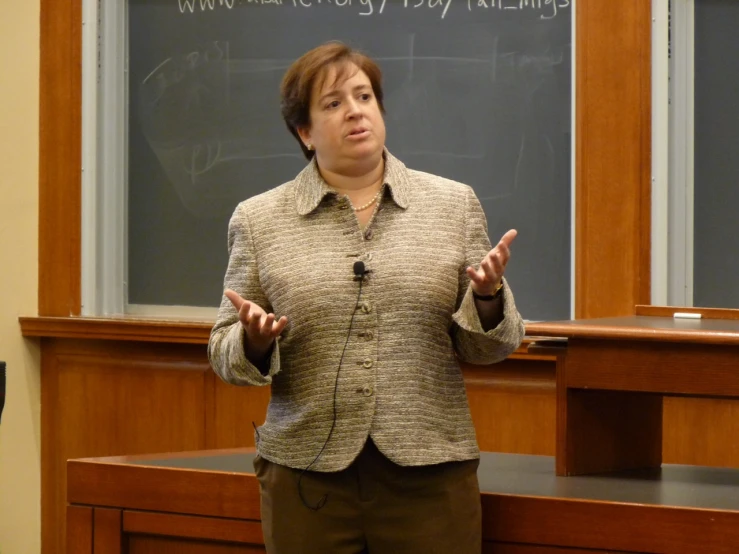 woman standing next to the blackboard in front of her