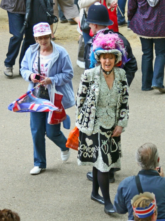 three people with hat in crowd wearing bright colors