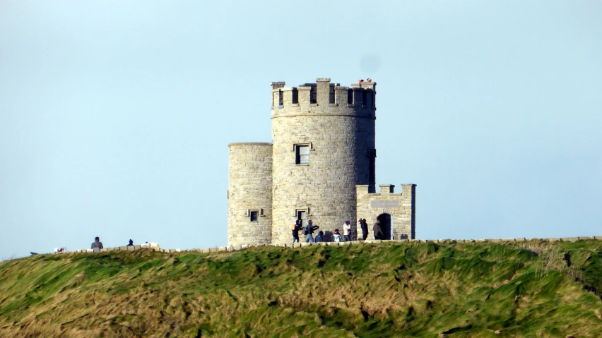 a group of people standing on the top of a large building