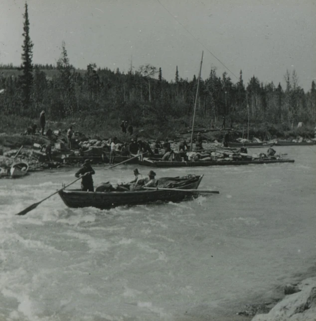 a group of people on canoes paddling down a river