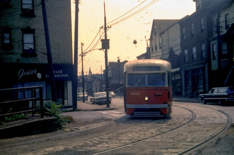 a trolley on a winding city road at dusk