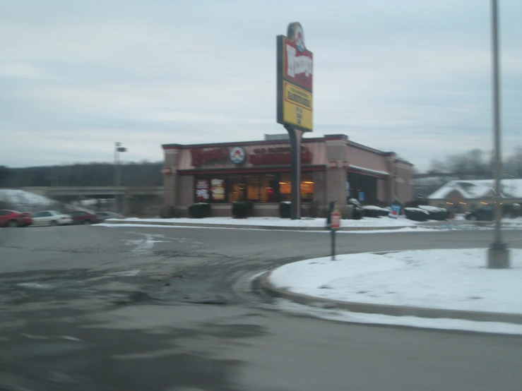 a mcdonald's sits on a street corner near an empty street