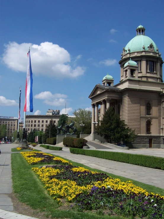 beautiful flowers are in front of the building