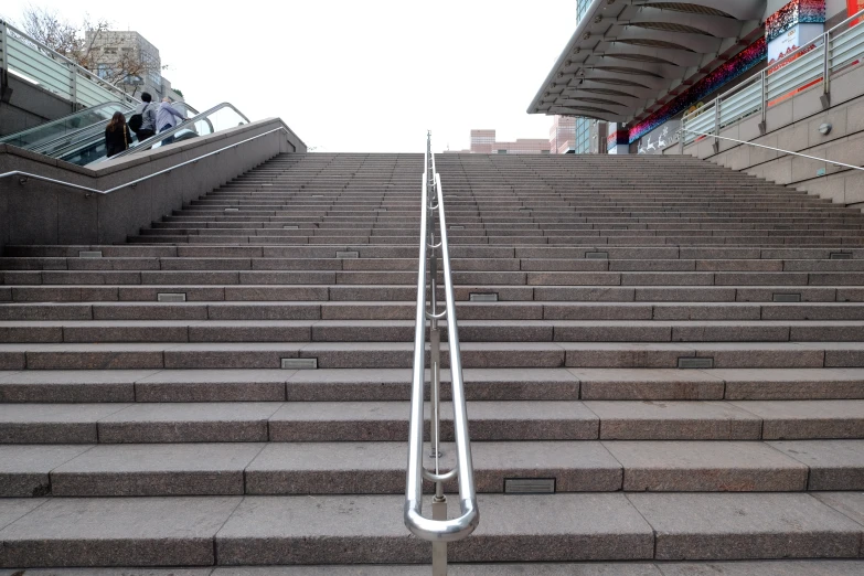 people are walking up a set of stairs