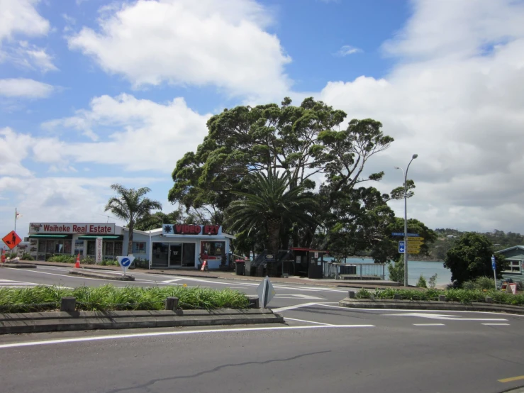 a small gas station on the corner of a city street