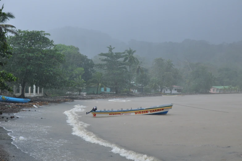 a boat in the water on an empty beach