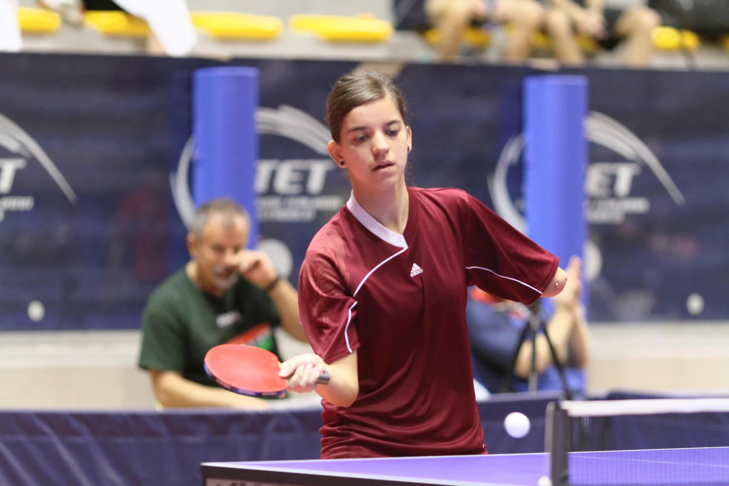 the young man is playing a game of table tennis