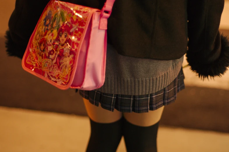 a woman's bag with japanese artwork on it
