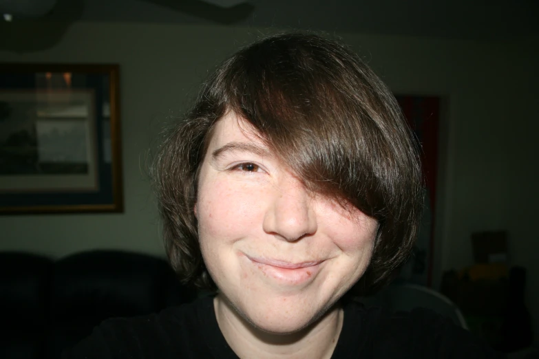 a smiling woman with black shirt in room