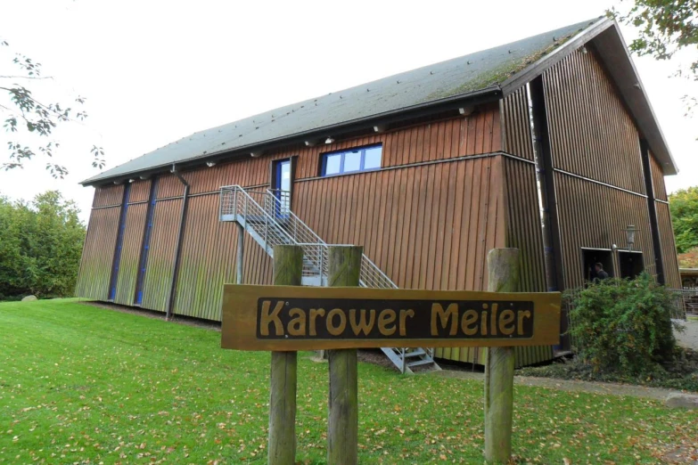 a brown building with a large wooden sign