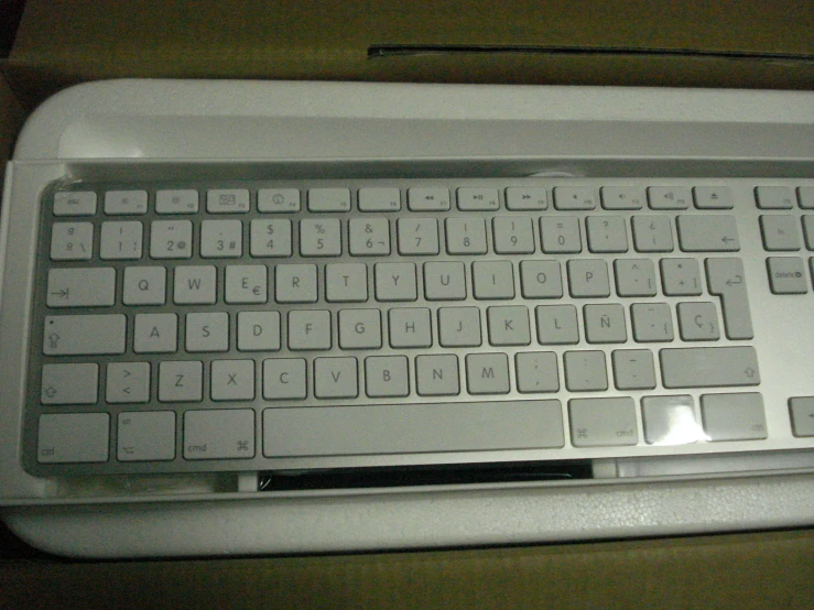 a computer keyboard sitting on top of a white desk