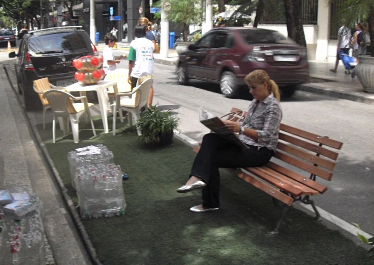 woman sitting on the bench using a digital tablet