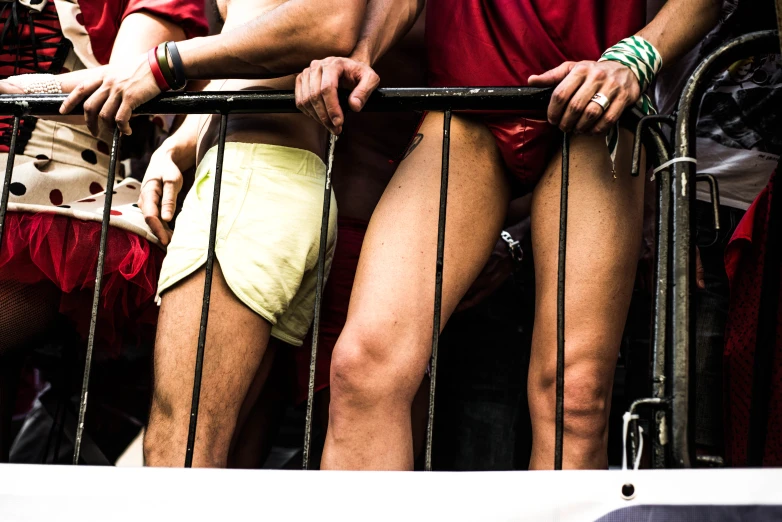 two men standing in front of a metal railing