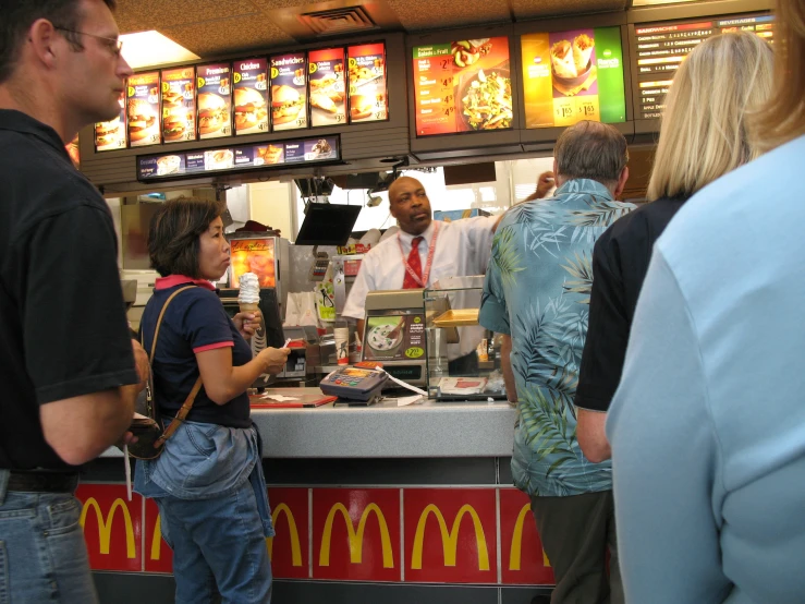 there is a man working the cash register at this fast food place