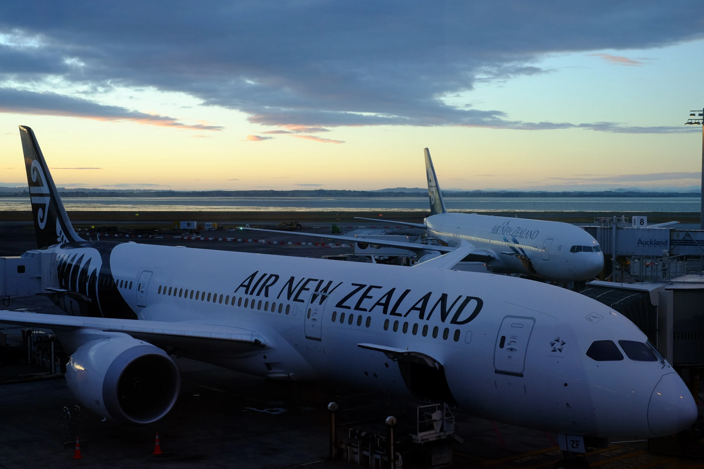 a large air new zealand airplane sitting at an airport