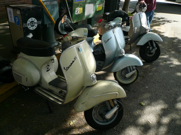 a couple of motor scooters parked on the side of the road