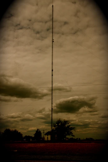 a tall tower stands in front of a cloudy sky