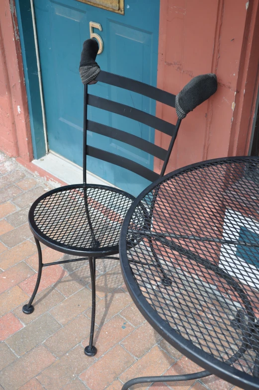 an outdoor table and chair on the ground