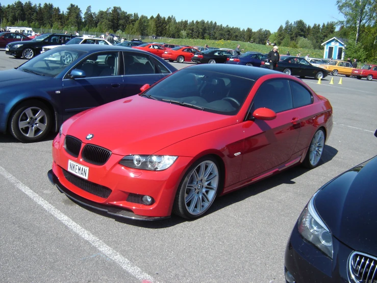 an orange car is parked in a parking lot