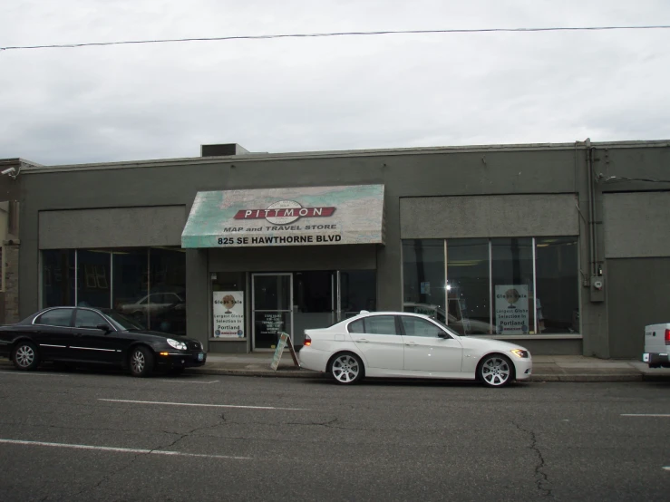 a street corner with three cars parked on the side of the street