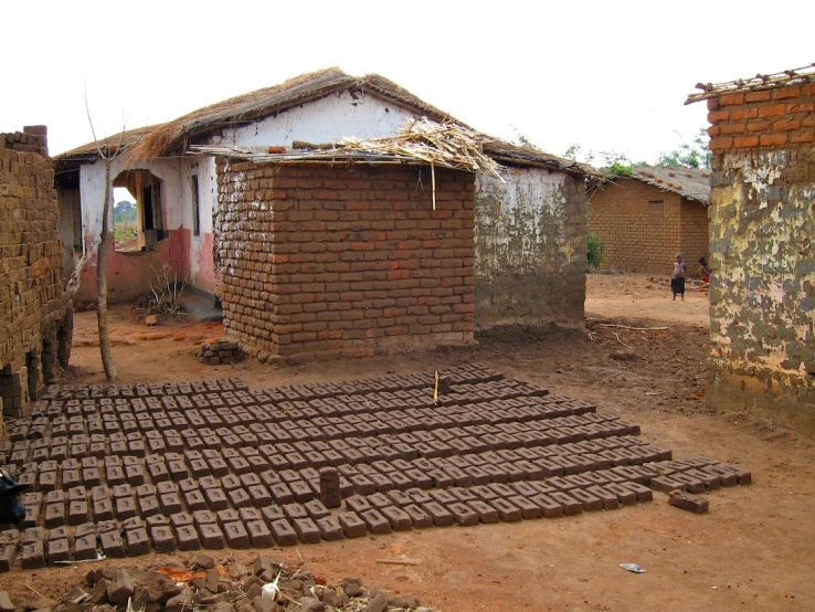 two brick buildings with several square blocks of bricks covering them