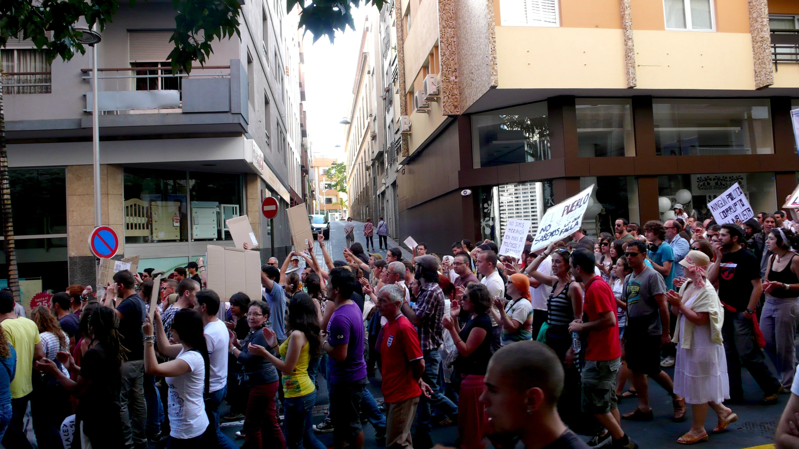 a crowd of people walking down the street