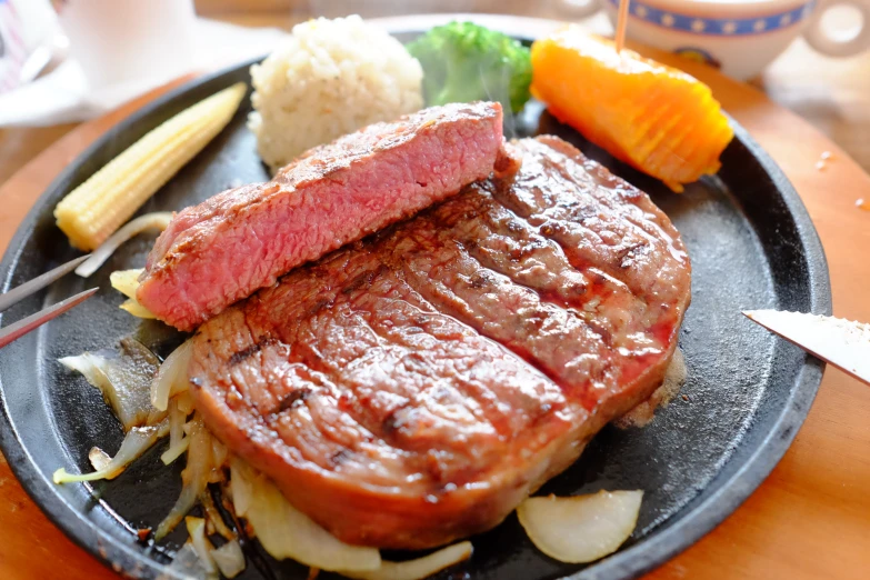 steak with vegetables and carrots on a plate