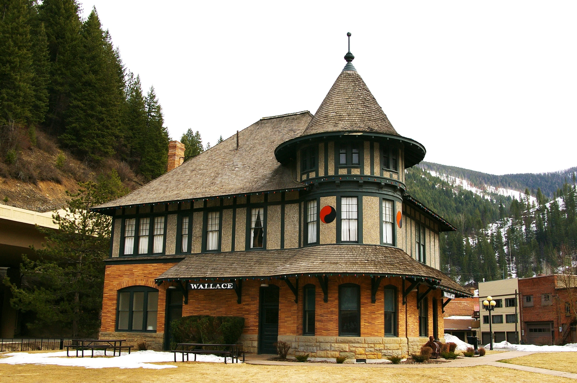 an old building sitting in front of a snow covered mountain