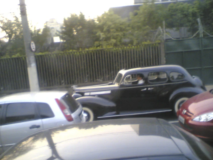 antique car parked on the side of street in residential area