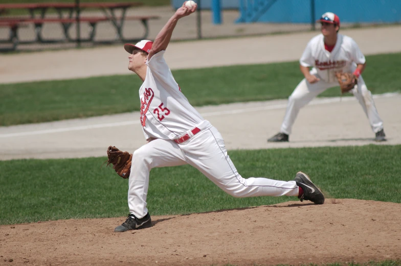 a pitcher in a baseball game winds up to throw the ball