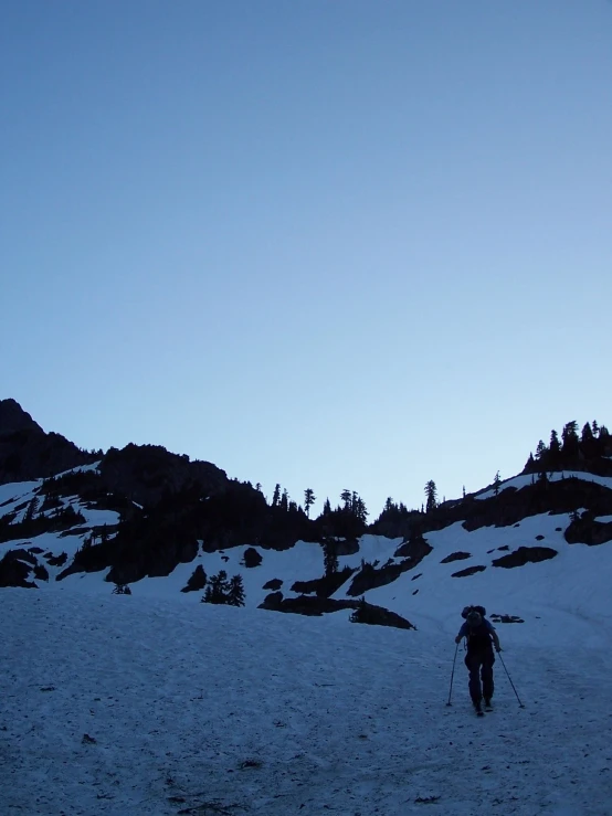 a person wearing skies in front of some mountains