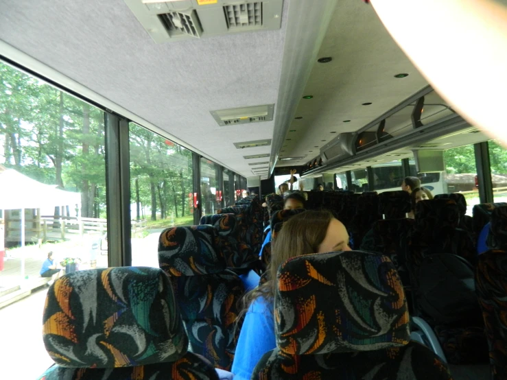 a long line of people sitting on a bus