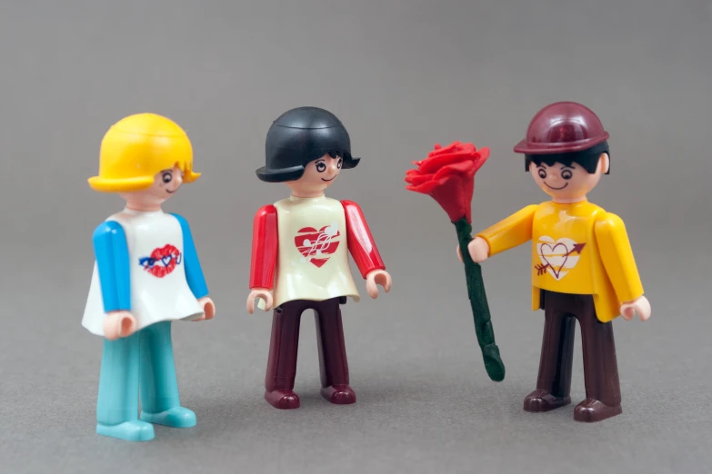 three toy action figures wearing construction gear